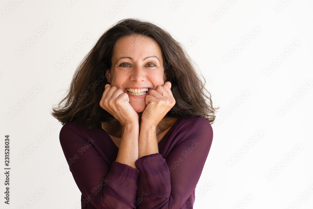 Happy confident woman holding hands on her chin. Attractive pensive senior woman looking at camera. Isolated on white. Satisfaction concept Happy confident woman holding hands on her chin. Attractive pensive senior woman looking at camera. Isolated on white. Satisfaction concept
