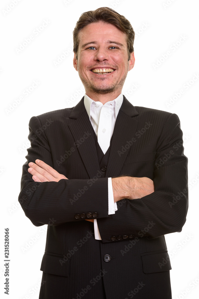 Happy Caucasian businessman wearing suit with arms crossed Happy Caucasian businessman wearing suit with arms crossed