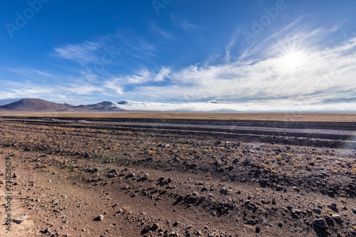 A panoramic view over the Atacama Desert valleys with the humidity coming from the sea and called "Camanchaca" on the far distance at the horizon line. An amazing desert landscape. 