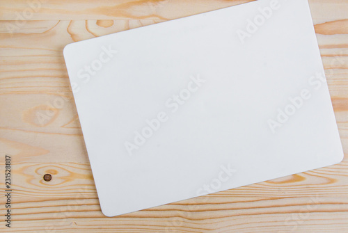 clean white sheet with rounded edges on a light-colored wooden background