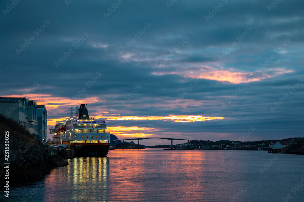 Passenger ship at quay in Bronnoysund with colorful clouds, Nordland county