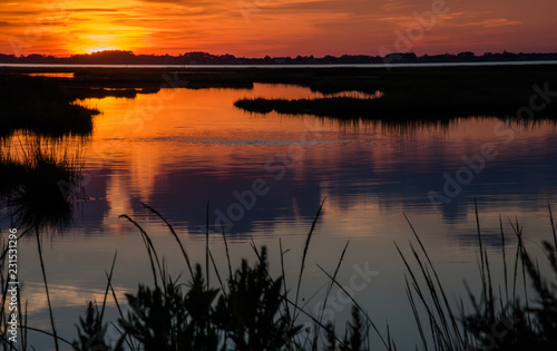 Sunset Sunrise over a marsh by the bay