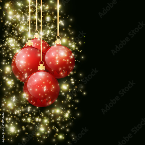 Christmas balls with falling spangles hanging on golden ribbons