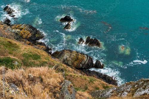 Fototapeta Irish landscape with rugged cliffs and emerald sea