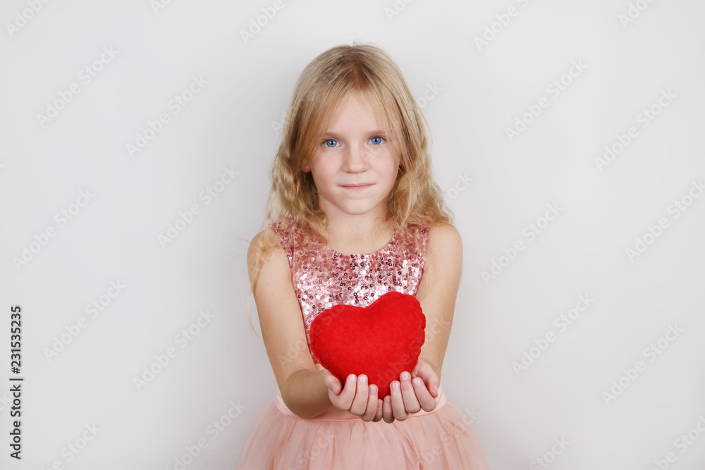 7322839 beautiful blond girl with red heart on a white background. Child with a heart for Valentine's day 7322839 beautiful blond girl with red heart on a white background. Child with a heart for Valentine's day