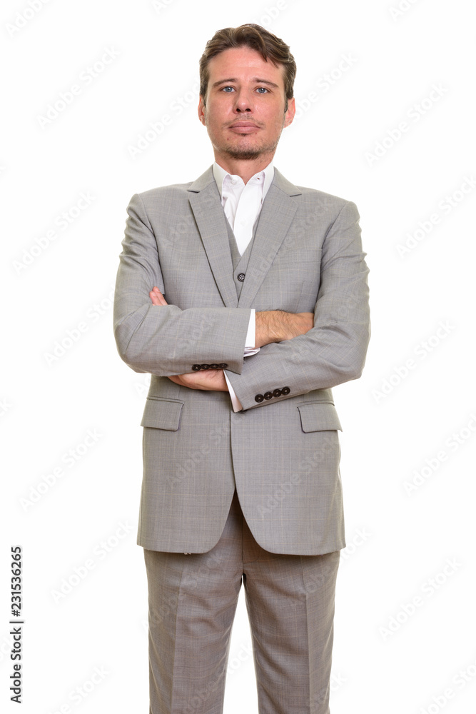 Handsome Caucasian businessman looking confident with arms crossed