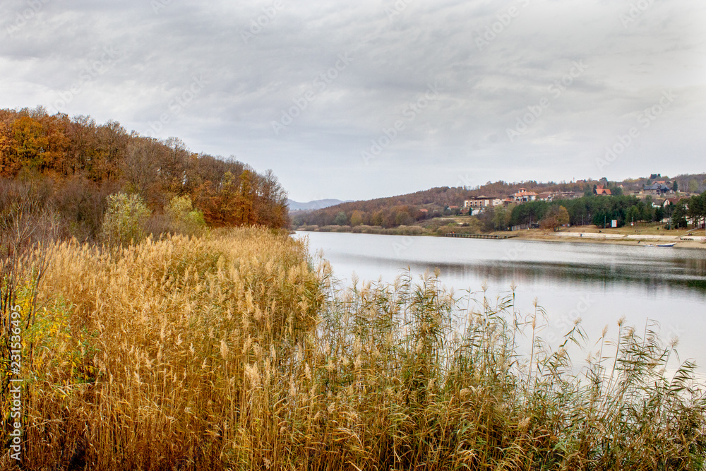 Beautiful lake surrounded by forest, sunset, cloudy day. Sumarice lake near the Kragujevac, Serbia. Beautiful lake surrounded by forest, sunset, cloudy day. Sumarice lake near the Kragujevac, Serbia.