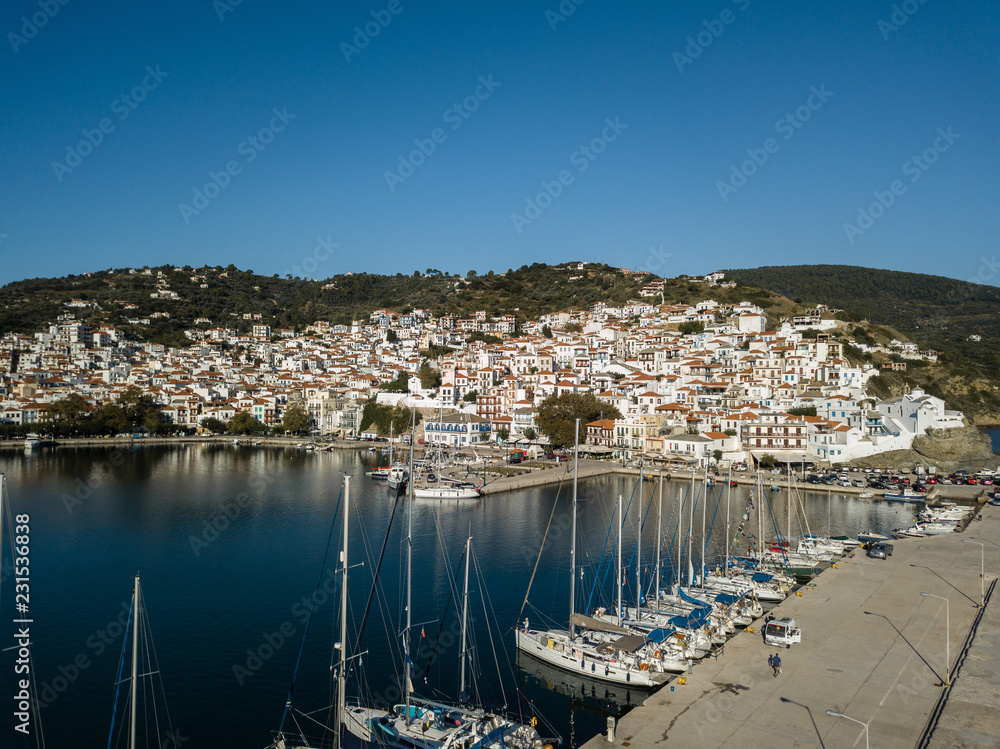 Old Town of Skopelos and harbor from above, island of Skopelos, Greece, Northern Sporades , Aegean Sea - Aerial Image by Drone