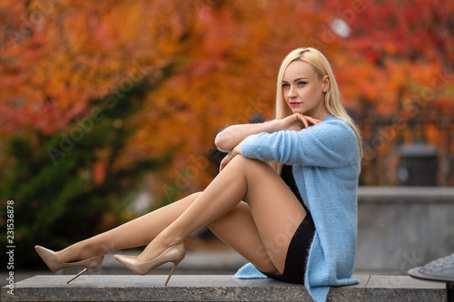 Girl with perfect legs posing in the autumn park. photo