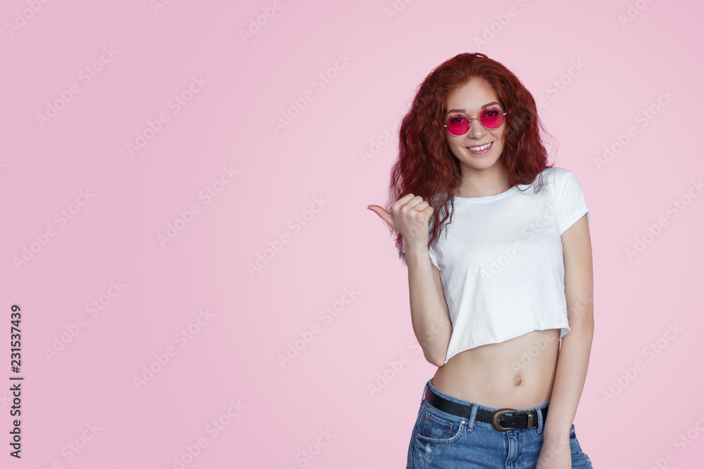 Pretty redhead woman pointing away Pretty redhead woman pointing away