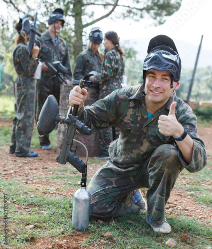 Male paintball player posing outdoors