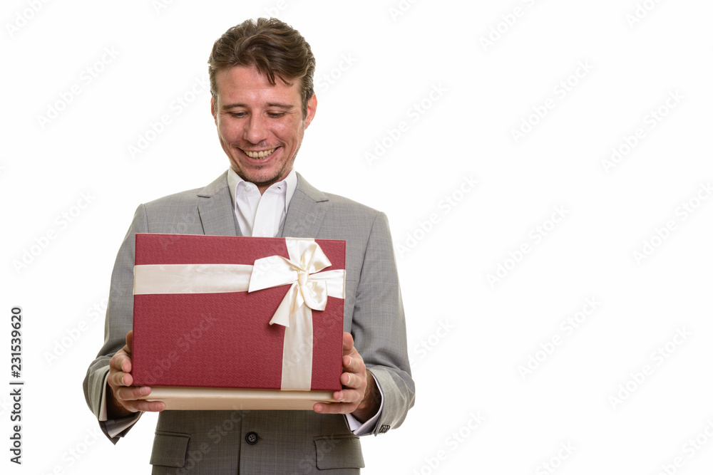 Portrait of happy businessman opening gift box while smiling Portrait of happy businessman opening gift box while smiling