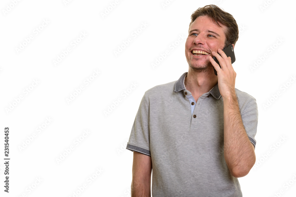 Happy Caucasian man talking on mobile phone