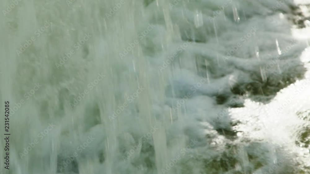 Cascading water froths, foams and splashes as it falls into a fountain Cascading water froths, foams and splashes as it falls into a fountain
