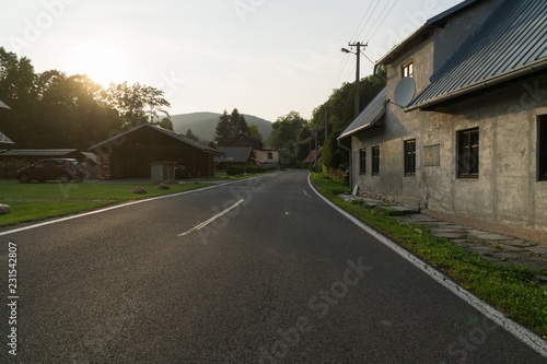 Fototapeta Naklejka Na Ścianę i Meble -  Street with road and houses in the village. Czech Republic