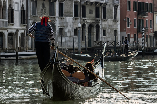 Venice, Italy - 2/21/2016. gondolier carries tourists by gondola, in canal Grande