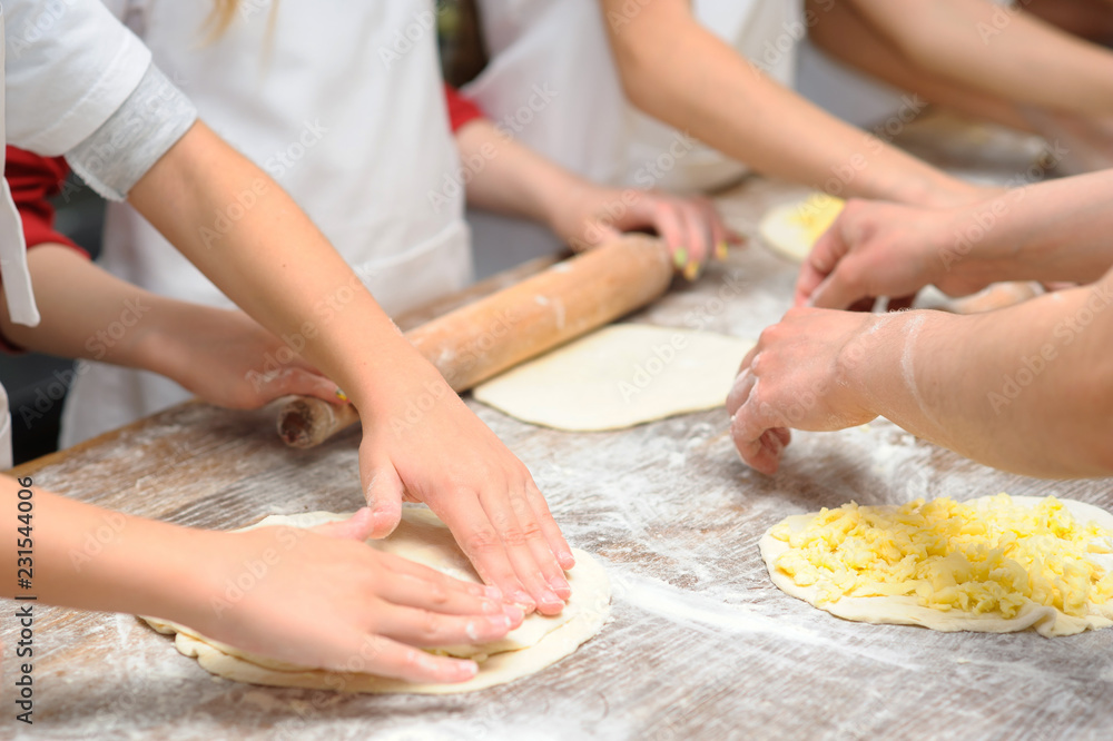 Young children make dough products. Hands closeup
Young children make dough products. Hands closeup