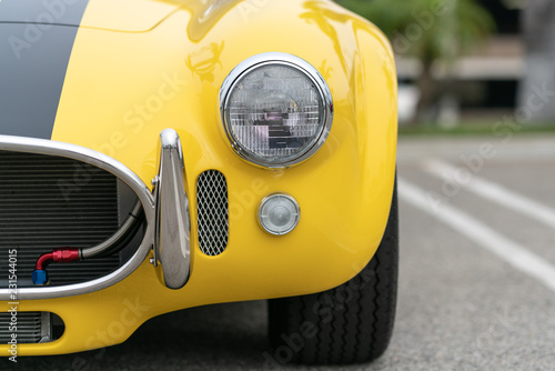 Close up of vintage yellow car bumber and lamps