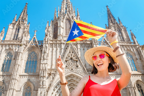Photography Young woman with Catalan flag in front of the famous Barcelona Eulalia Cathedral