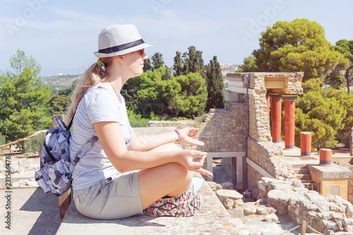 Young woman meditating over ancient city landscape