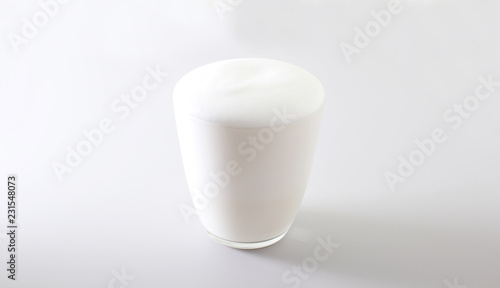 milk foam glass on a light background