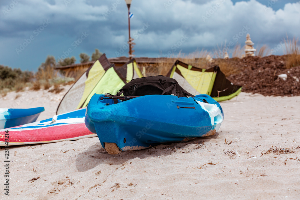 Active rest, sport, kayak. Boat for rafting on water. A few kayaks stand on a sandy beach. Active rest, sport, kayak. Boat for rafting on water. A few kayaks stand on a sandy beach.