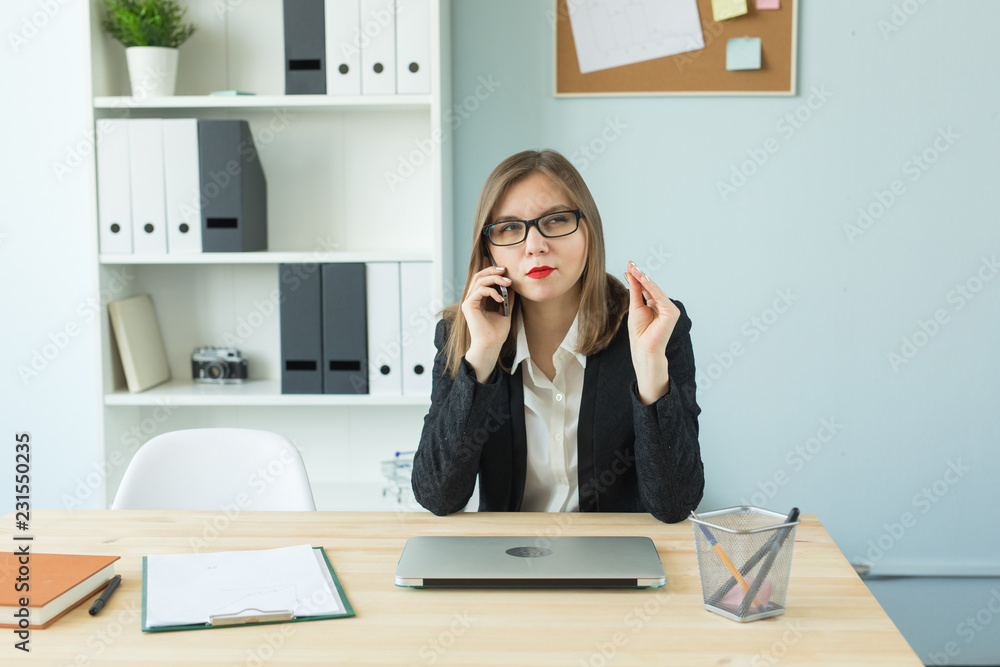 Business, realtor and people concept - Attractive woman in office talking on phone and make notes Business, realtor and people concept - Attractive woman in office talking on phone and make notes