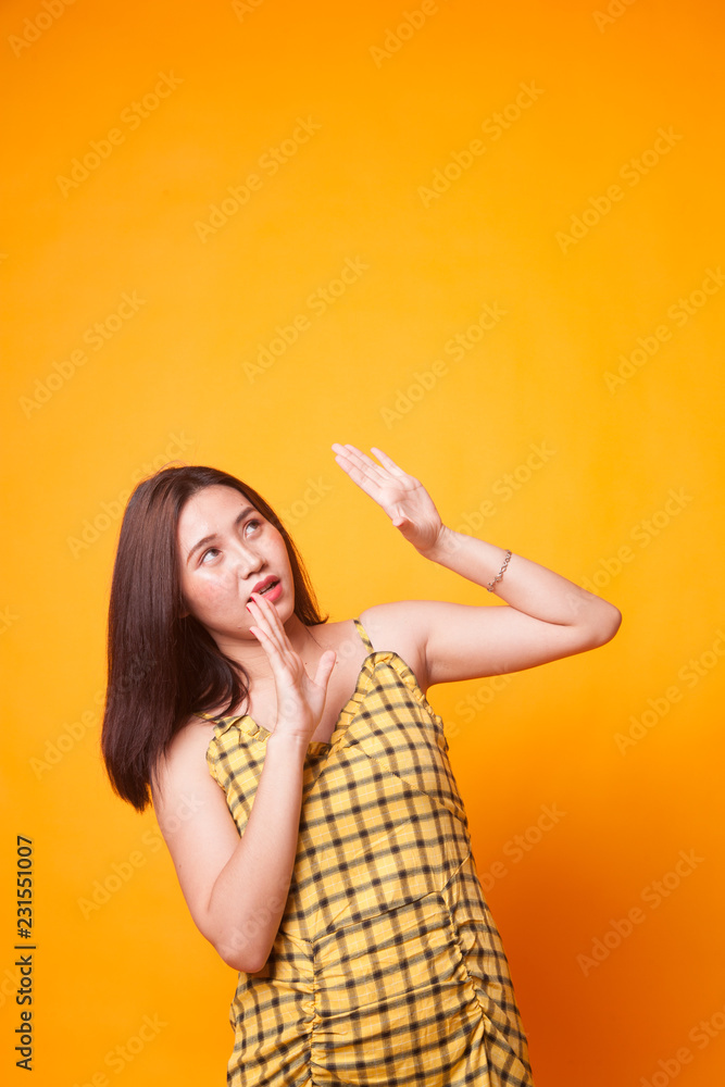 Excited young Asian woman look up. Excited young Asian woman look up.