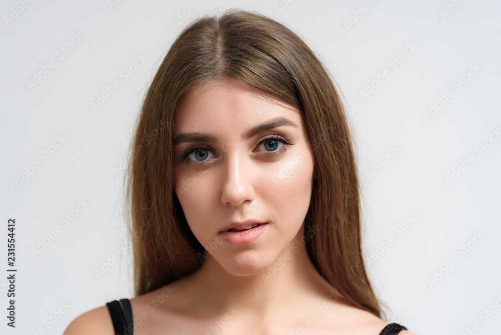 Studio portrait of a smiling happy beautiful brunette girl on white background. Studio portrait of a smiling happy beautiful brunette girl on white background.