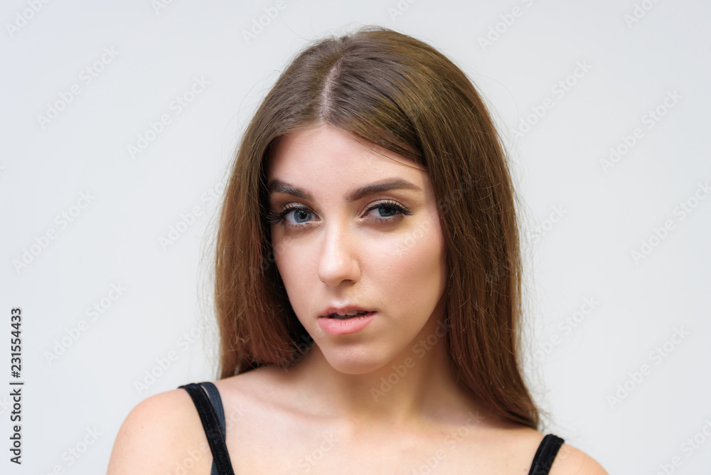 Studio portrait of a smiling happy beautiful brunette girl on white background. Studio portrait of a smiling happy beautiful brunette girl on white background.