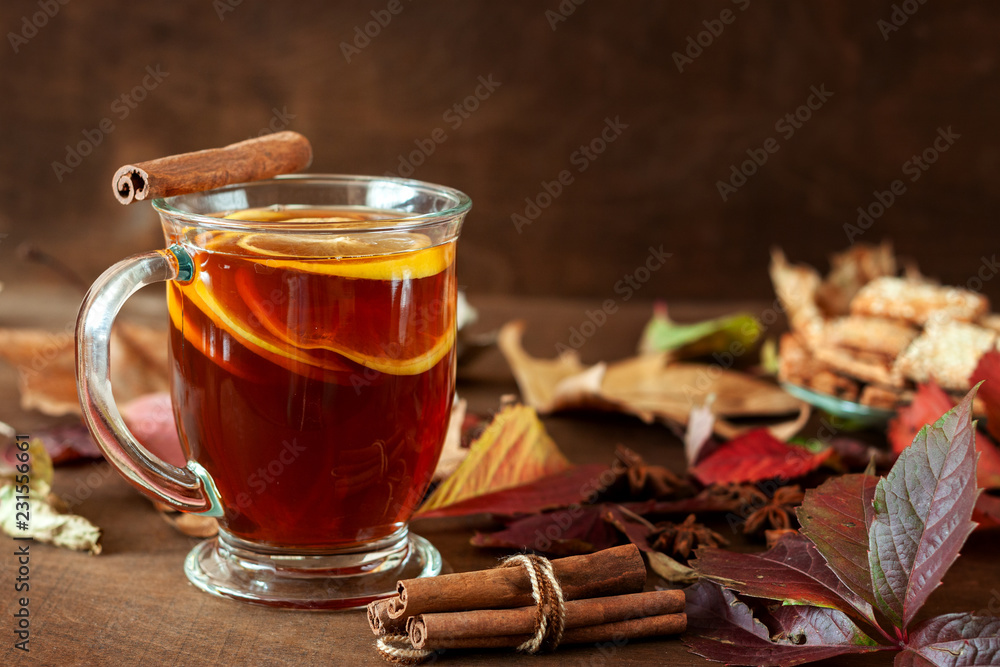 A cup of hot tea on the background of autumn foliage A cup of hot tea on the background of autumn foliage