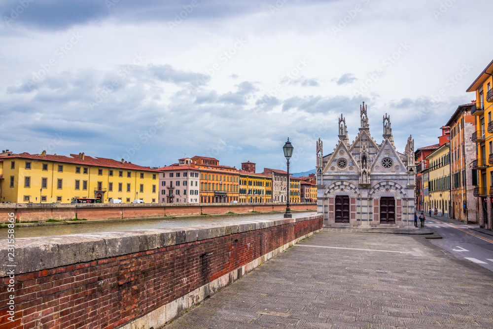 monuments and buildings in Pisa on the Arno river in Tuscany