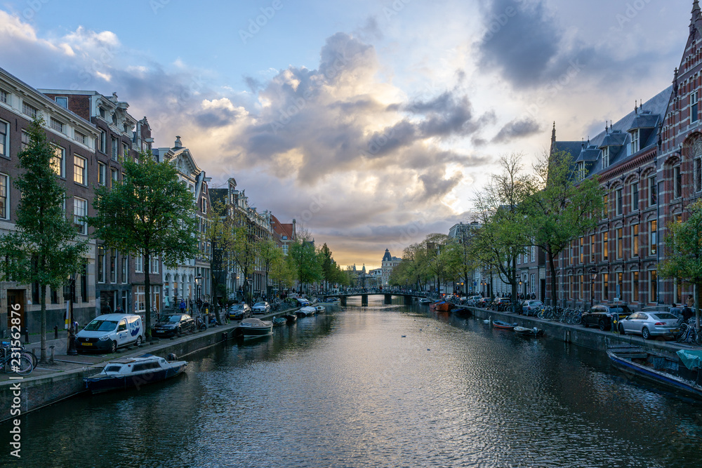 Amsterdam canal before sunset, dramatic sky