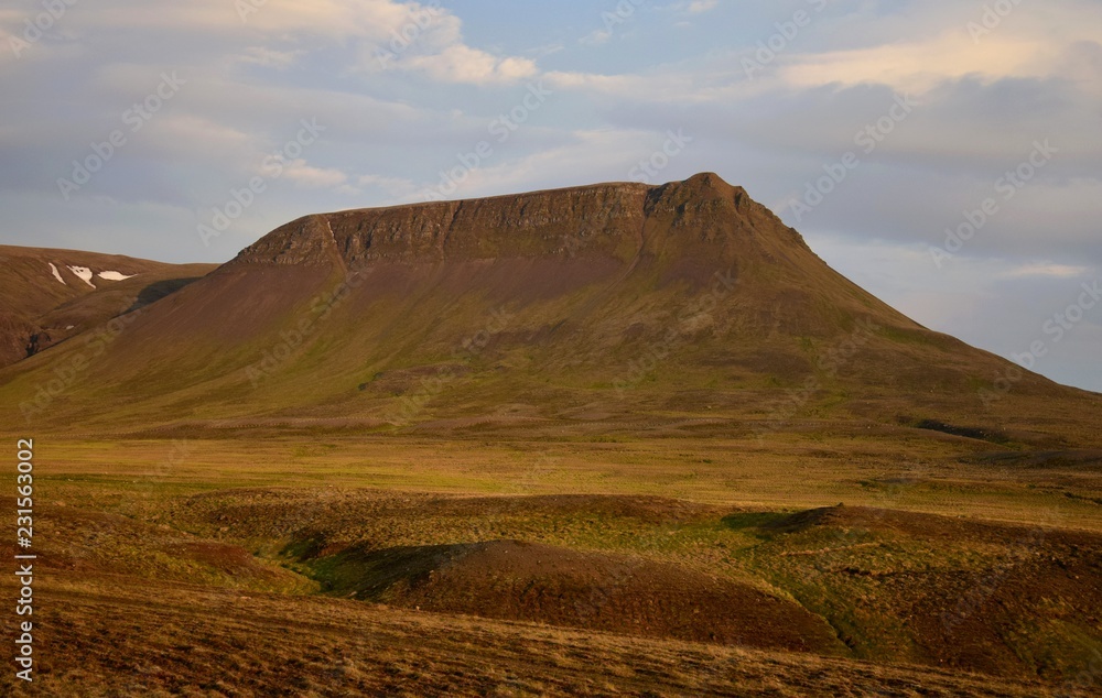 A midsummer night in Iceland. A mountain is glowing in the midnight sun. The Vatnsdalsfjall near Blönduos.