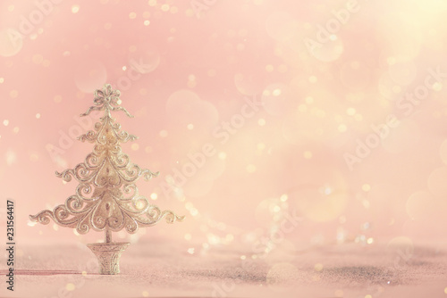 Silver glitter Christmas tree on pink background with lights bokeh, copy space. Greeting card for new year party. Festive holiday concept