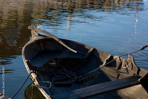 Photography Stern of a tared rowing boat in the harbour of stockholm a sunny autumn morning