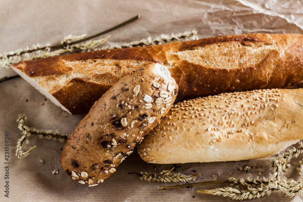 mix of different varieties of bread lying on a wooden table mix of different varieties of bread lying on a wooden table