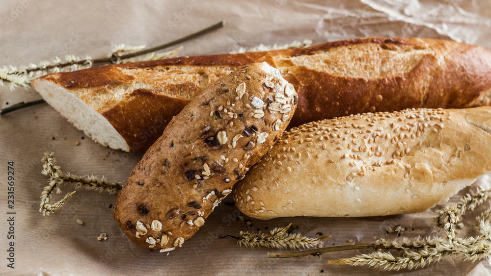 mix of different varieties of bread lying on a wooden table mix of different varieties of bread lying on a wooden table