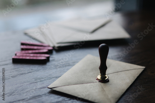 Envelope with stamp and wax on wooden table
