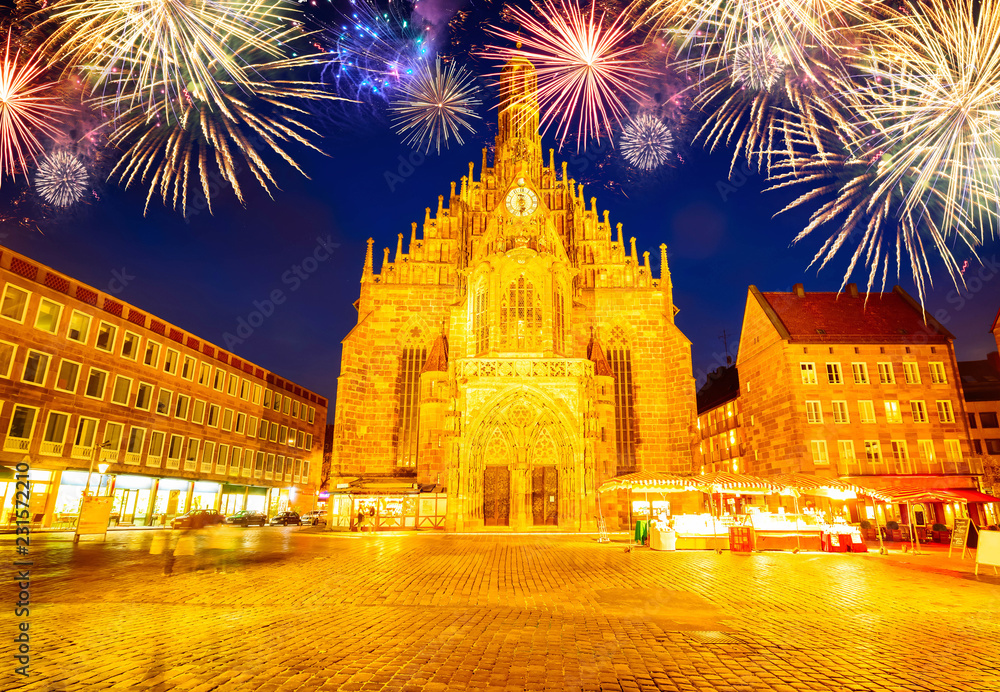 Old town with Nuremberg cathedral church at night with fireworks, Germany