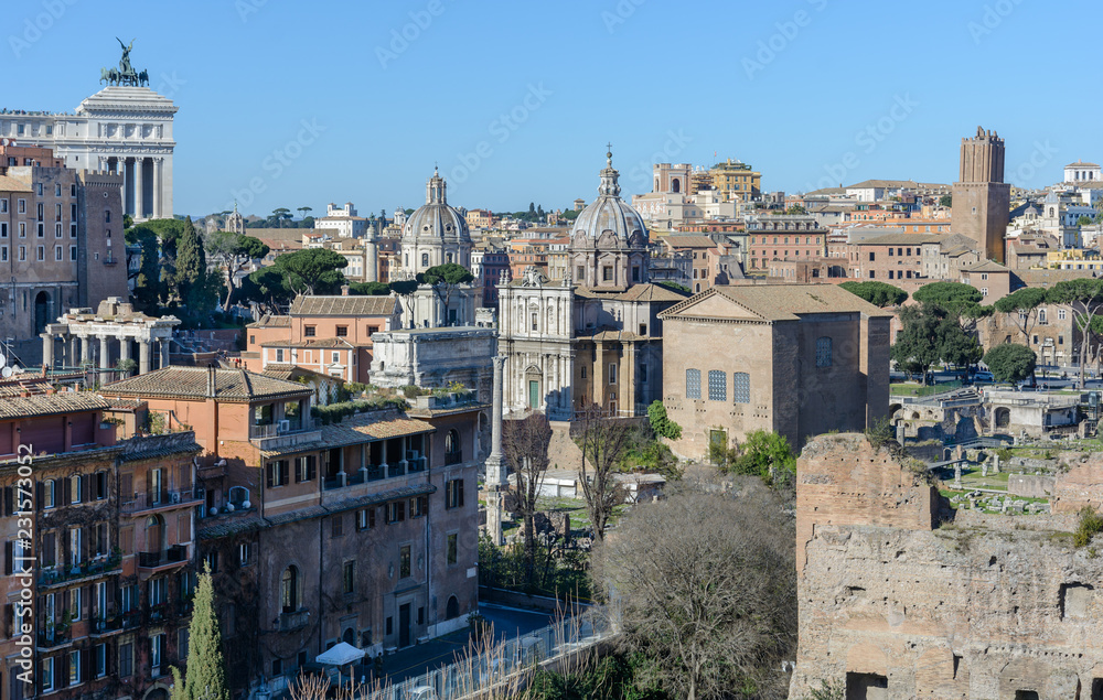 View of the Roman Forum and the city of Rome from Palatine Hill. The forum with its adjoining buildings is located in the center of ancient Rome. Temples, arches, basilicas and other buildings. 