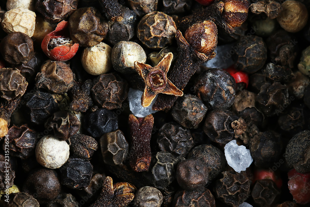 Obraz premium Seasoning - four kinds of pepper peas. pepper background. Close up, selective focus, copy space