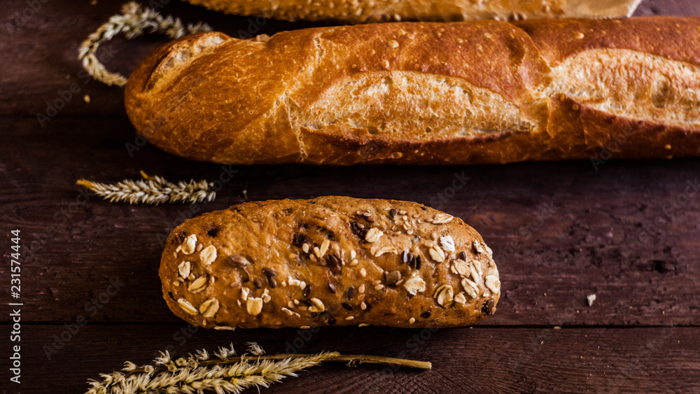 mix of sorts of baguettes on a wooden table. Bakery products. mix of sorts of baguettes on a wooden table. Bakery products.