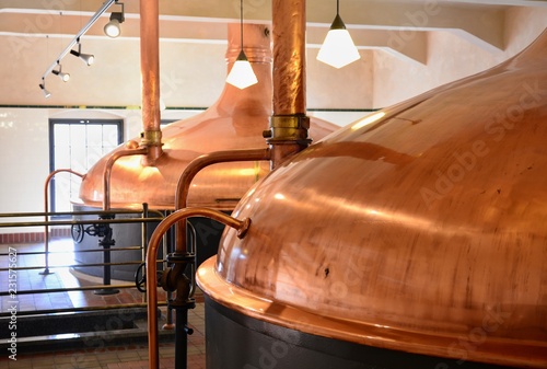 View of beer brewery interior with traditional fermenting copper vats. photo