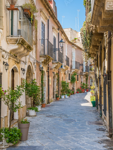 A narrow and picturesque road in Ortigia, Siracusa old town, Sicily, southern Italy.