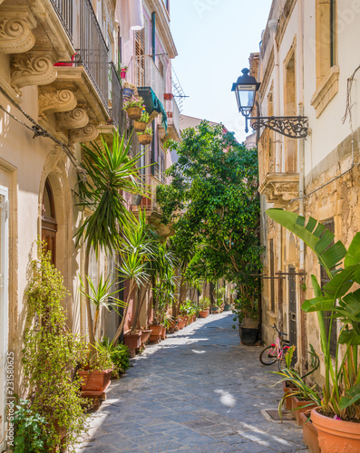 A narrow and picturesque road in Ortigia, Siracusa old town, Sicily, southern Italy. photo