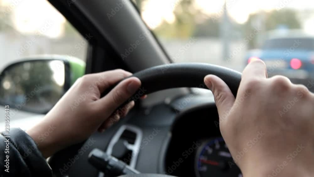 A man in a car driving a car through the streets A man in a car driving a car through the streets