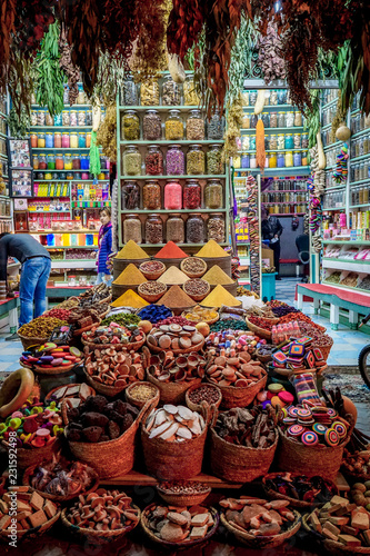 Fototapeta Naklejka Na Ścianę i Meble -  A colorful spice stall at night, with jars and piles of spices in Rahba Kedima Square in Marrakesh, Morocco