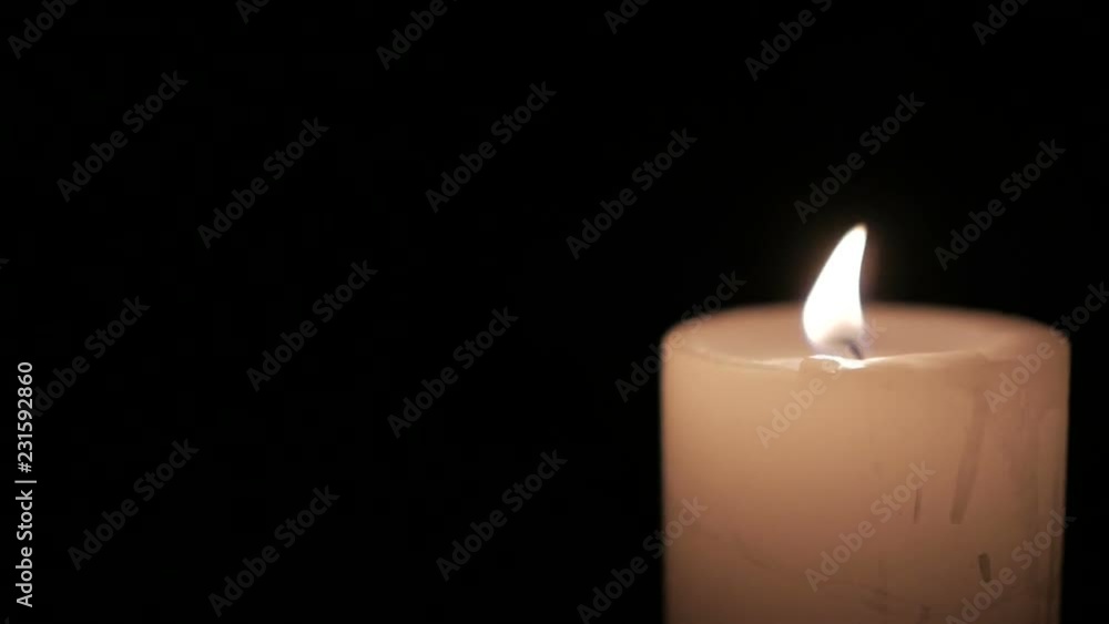 Closeup of burning candle isolated on black background. Closeup of burning candle isolated on black background.