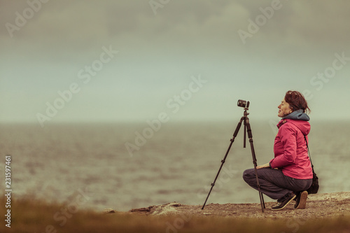 Tourist with camera on seashore, Norway